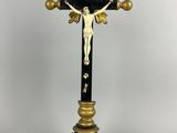 a black and gold cross with a crucifix on it