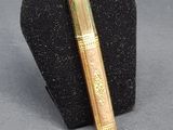 a pen and a lighter on a display stand