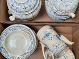 a box of blue and white china dishes and cups