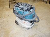 a vacuum that is sitting on the floor in the room