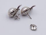 pair of silver plated earrings and a button on a white surface