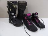 pair of black and pink motorcycle boots sitting on top of a white table