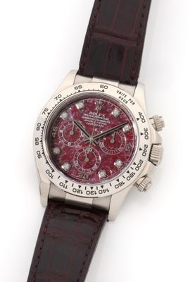 an image of a wrist watch with a red dial and brown leather strap