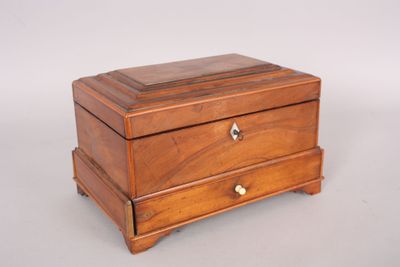 an antique wooden box with two drawers on top of it
