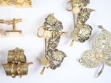 a lot of gold and silver jewelry on a white surface