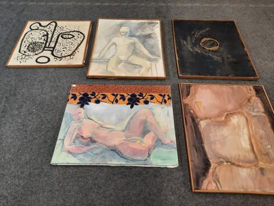 four framed paintings of nudes and a woman on a table