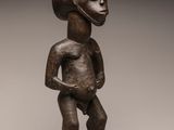an image of a statue of a man standing on a wooden base