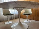 two chairs that are sitting around a marble table