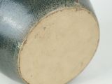 a close up of a vase on a white surface