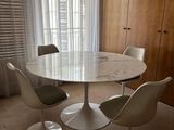 three chairs around a round table in a room