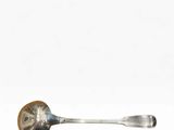 a silver spoon with a wooden handle on a white surface