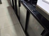 several refrigerators and freezers are lined up in a store