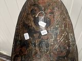 a person holding a helmet that has a picture on it