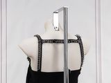 a mannequin with a black dress on a mannequin stand