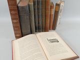 several old books are stacked on top of each other on a table