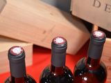 three bottles of wine sitting on a table next to a wooden box