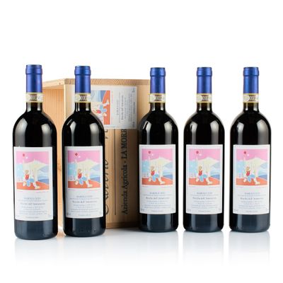 trois bouteilles de vin rouge sont alignées devant une boîte