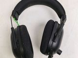 a pair of black headphones on a white surface
