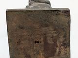 a small statue of a person sitting on a bench