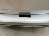 a close up of a car ' s bumper with a clock on it