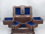 a small wooden box with two open compartments on a table