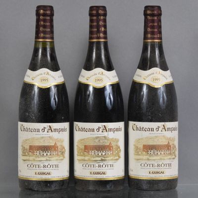 three bottles of wine are lined up on a table