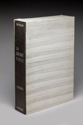 a book sitting on top of a white table next to a gray wall