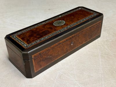 an old wooden box sitting on top of a white surface
