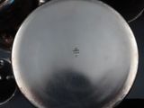 a close up of a silver plate on a table