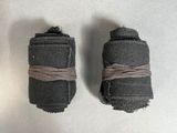 two pieces of black fabric wrapped around each other on a white surface