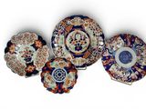 five plates with different designs and designs on them on a white surface
