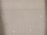 a close up of a bed with a white comforter and a pillow