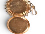 a gold locke with a picture of a woman on it