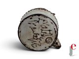 a white cup with writing on it sitting on a white surface