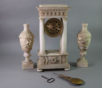 a clock and a pair of scissors on a table