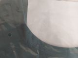 a green sweater sitting on top of a white table