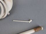 a cigarette and a bone on a table