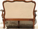 a wooden bench with a beige upholstered back