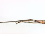 a rifle with a wooden barrel on a white background