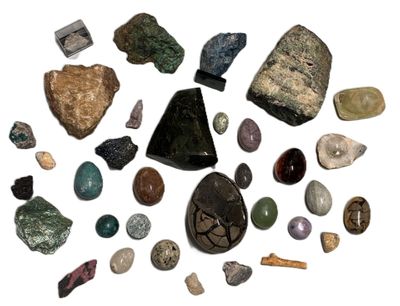 various types of rocks and stones arranged in a circle on a white surface