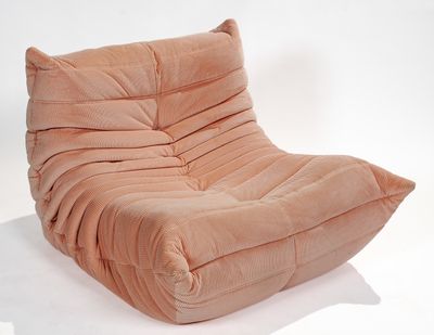 a pink chair that is sitting on a white surface