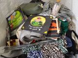 a pile of clothes and books in a trash can