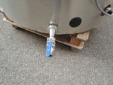 a metal tank that has a hose attached to it