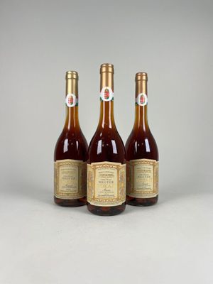 three bottles of wine sitting next to each other on a table