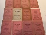 several pink menus are arranged on a white table top