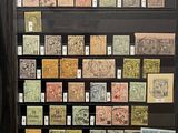 a display of stamps on display in a glass case