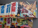 a lot of comic books sitting on top of each other