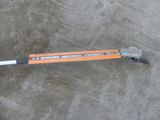 an orange and black pole that is laying on the ground