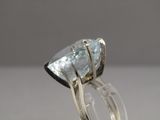 a close up of a ring with a blue topaz stone