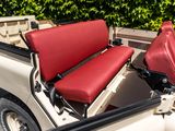 two red seats in the back of a white truck